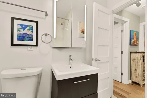 a bathroom with a sink a toilet and a mirror