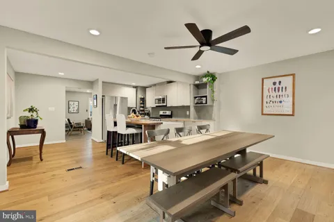 a living room with stainless steel appliances furniture and a window