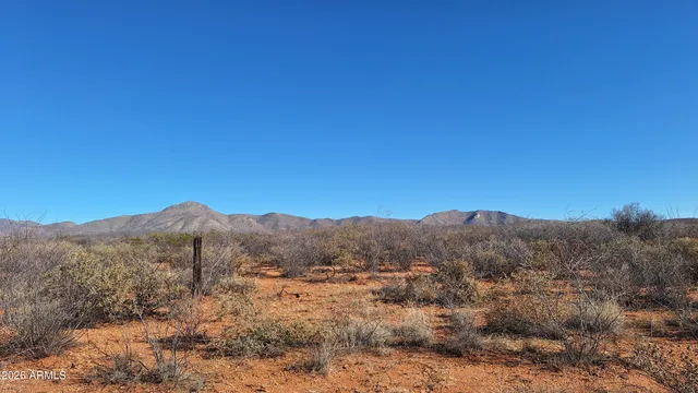 a view of mountain and grassy field