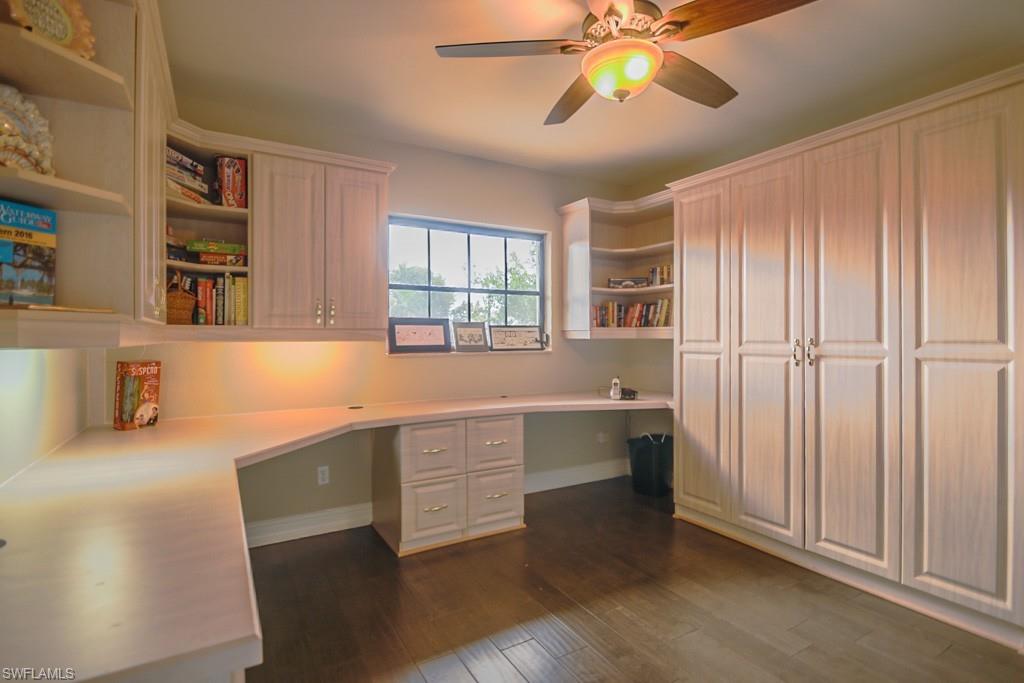 496 Flamingo Avenue Naples, FL 34108 - Photo 12 of 15 Unfurnished office with ceiling fan, dark wood-type flooring, and built in desk