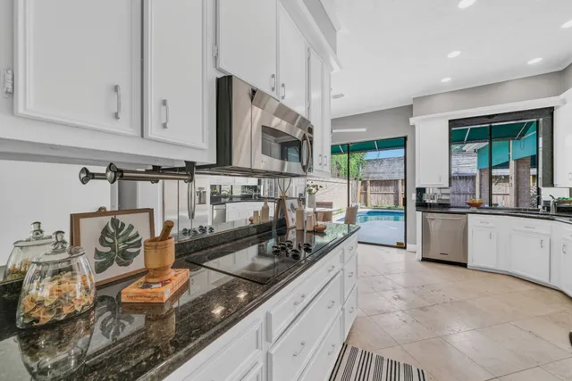 a kitchen with stainless steel appliances granite countertop a sink and cabinets