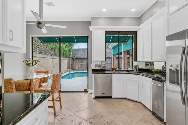 a kitchen with stainless steel appliances granite countertop sink stove and cabinets