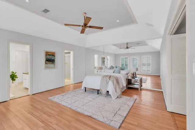 a bed room with a bed and ceiling fan