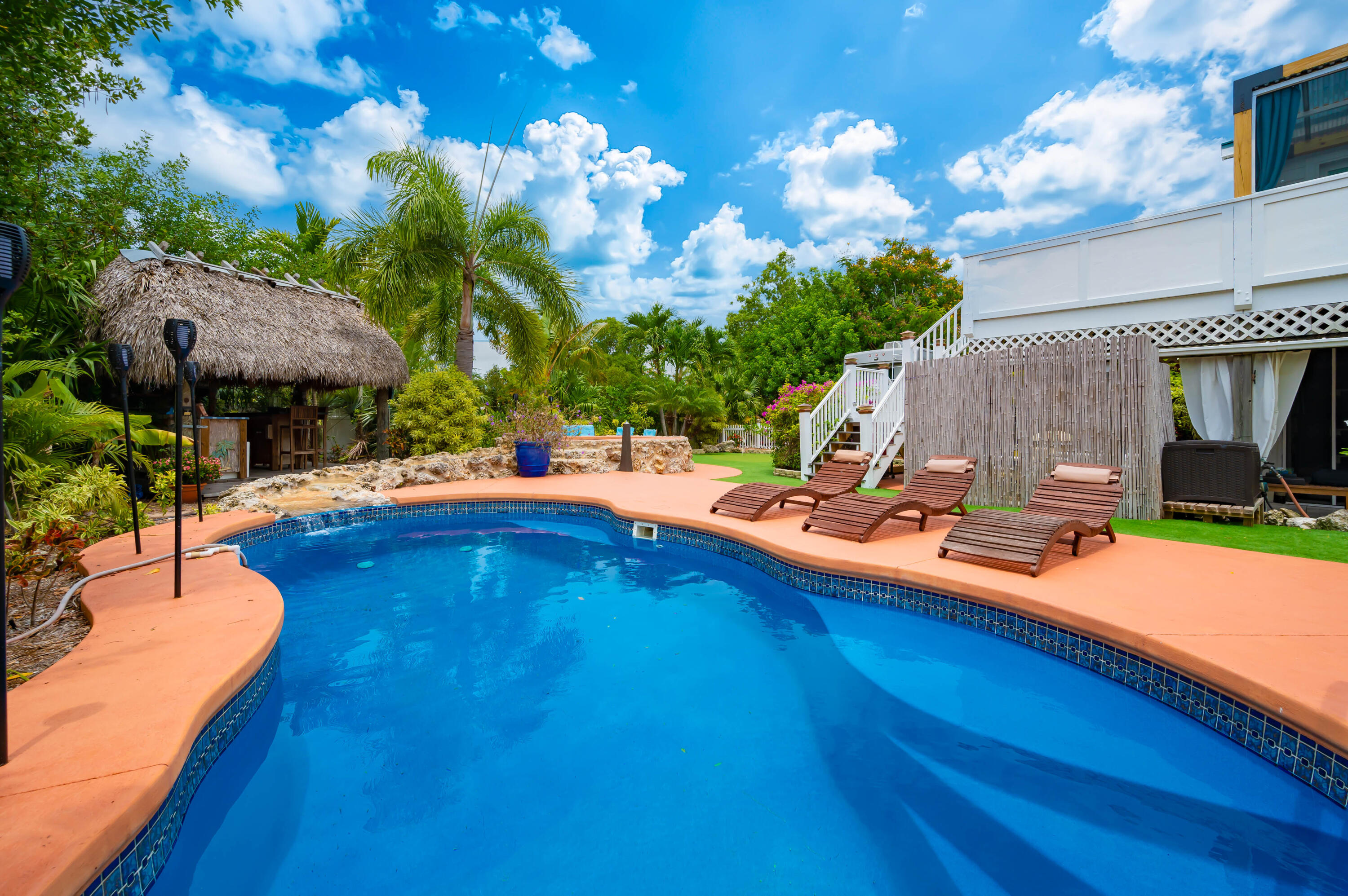 29072 Cedar Drive Big Pine Key, FL 33043 - Photo 3 of 59 a view of a swimming pool with a patio and a garden