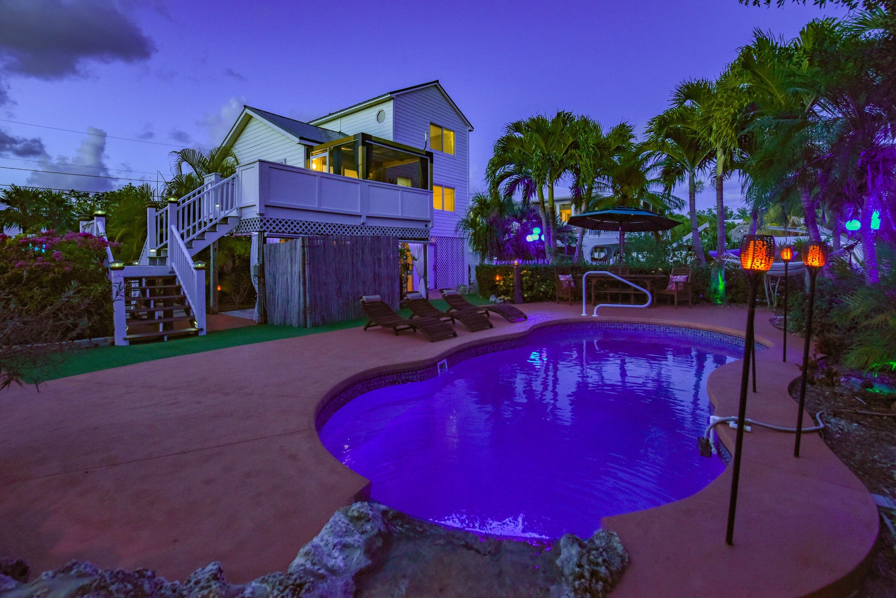29072 Cedar Drive Big Pine Key, FL 33043 - Photo 32 of 59 a view of a red building with swimming pool in front of it