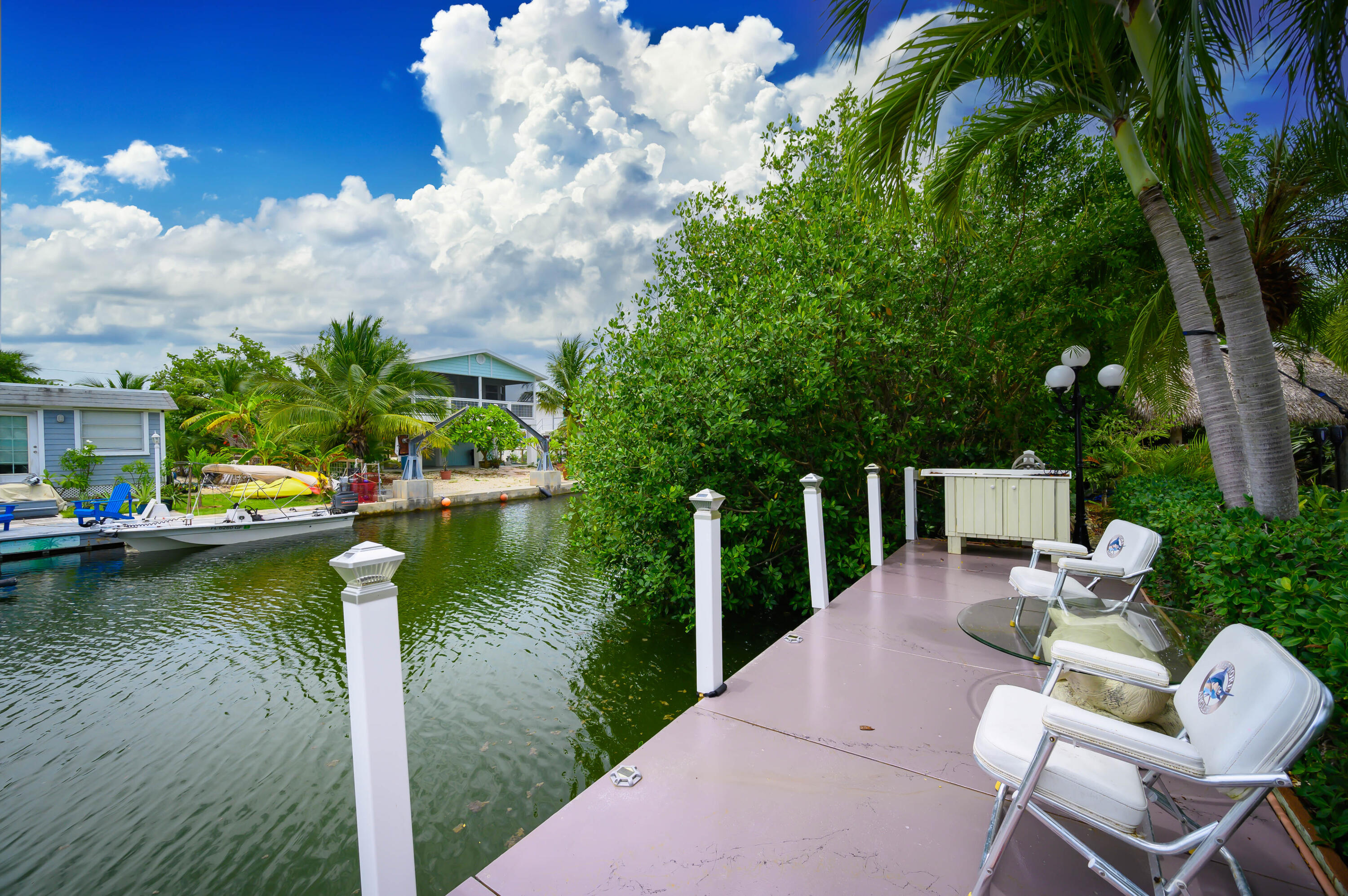 29072 Cedar Drive Big Pine Key, FL 33043 - Photo 45 of 59 a view of a lake with couches chairs and swimming pool