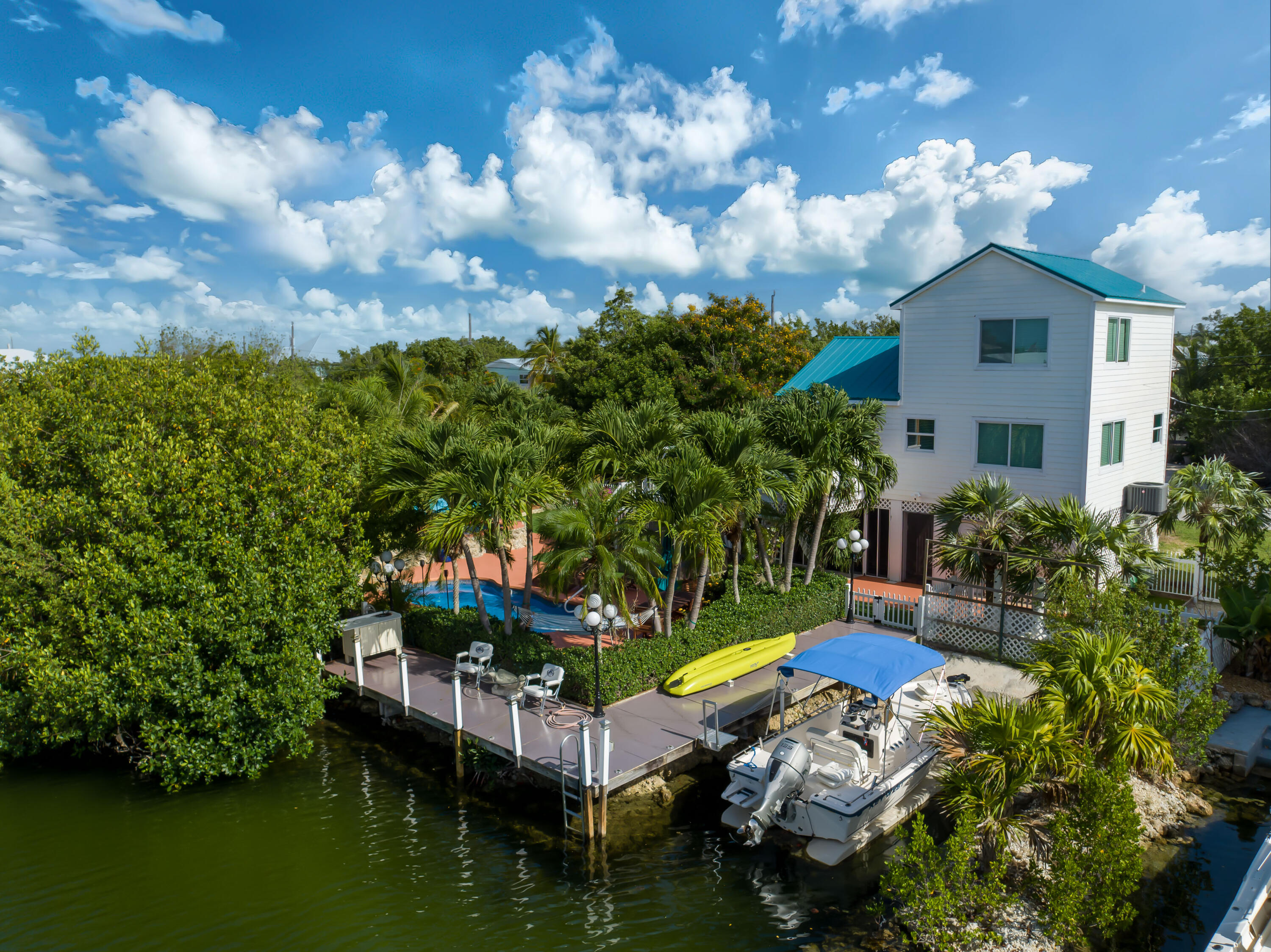29072 Cedar Drive Big Pine Key, FL 33043 - Photo 55 of 59 a aerial view of a house with swimming pool a patio and lake view