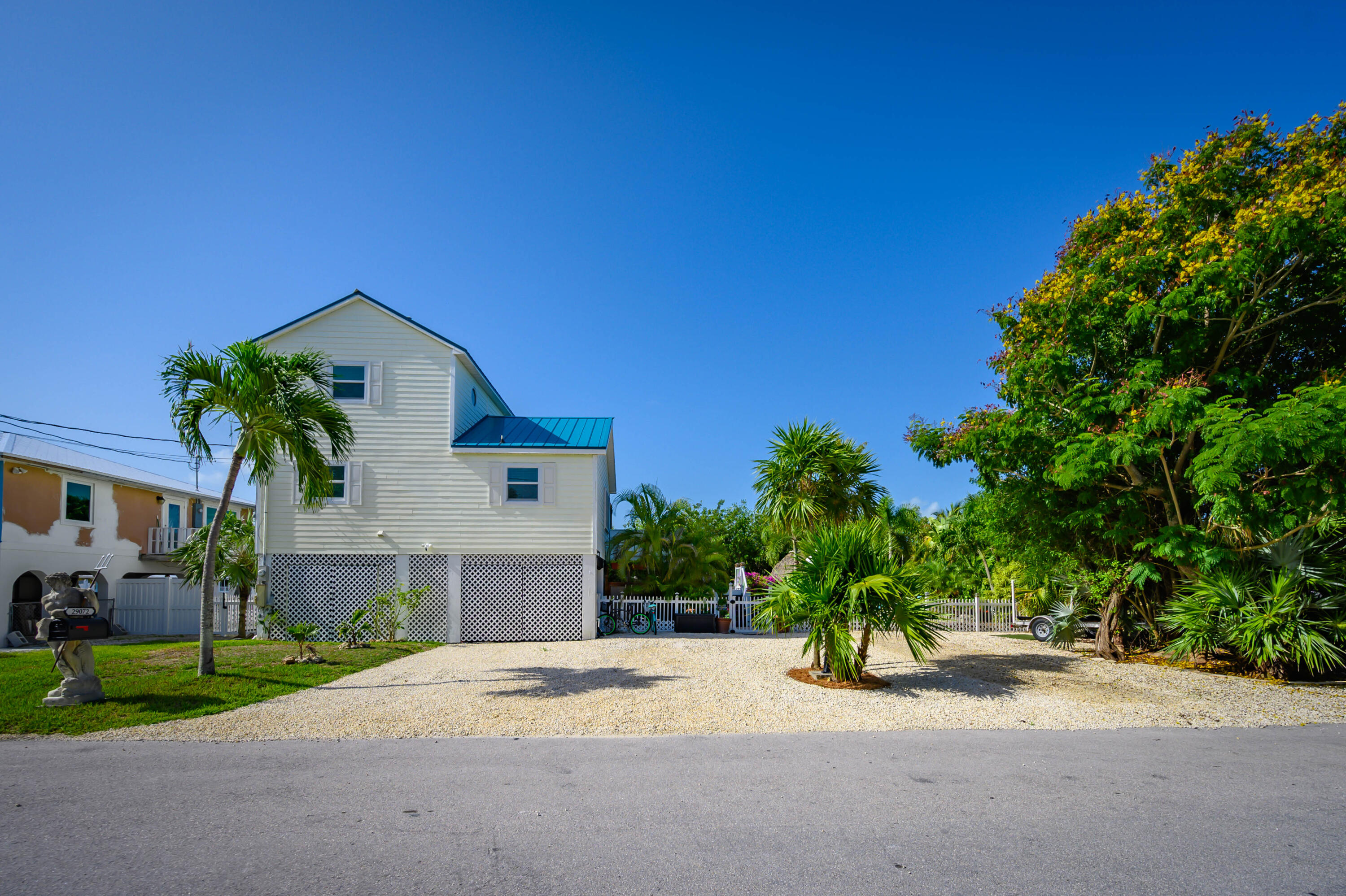 29072 Cedar Drive Big Pine Key, FL 33043 - Photo 6 of 59 a front view of a house with a yard and garage