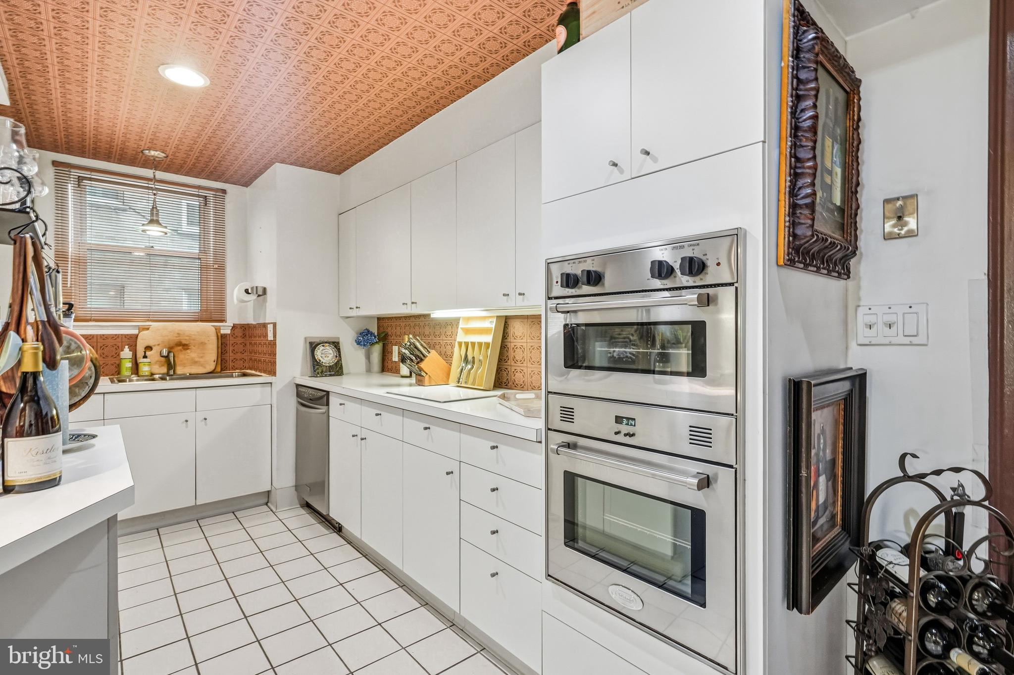 1901 Walnut Street, Unit 6F Philadelphia, PA 19103 - Photo 15 of 32 a kitchen with granite countertop white cabinets and white appliances