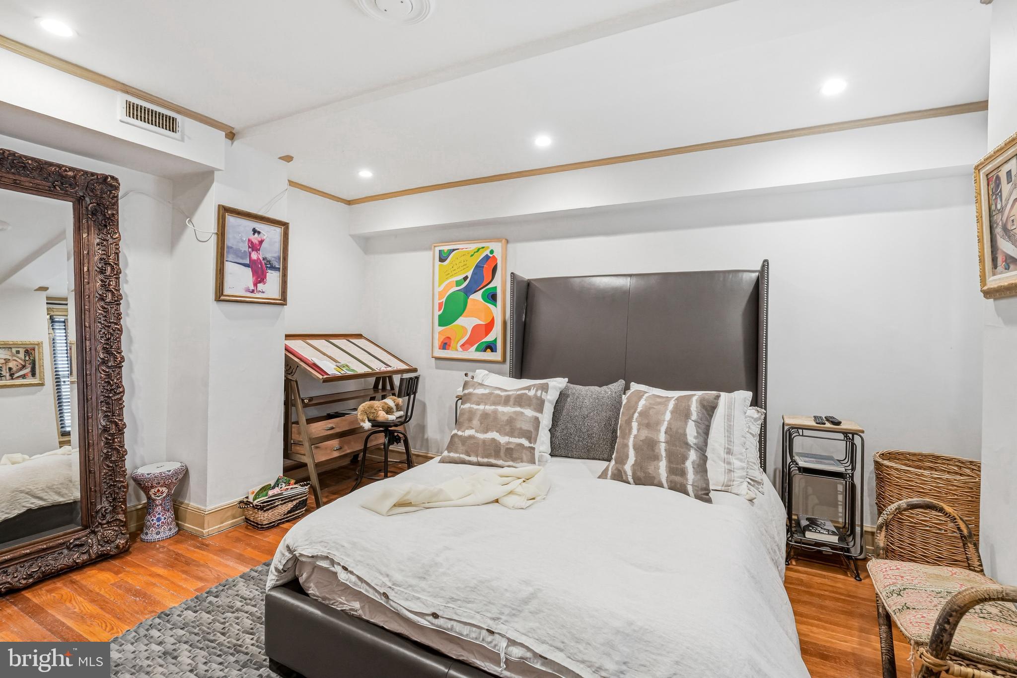 1901 Walnut Street, Unit 6F Philadelphia, PA 19103 - Photo 19 of 32 a bedroom with a bed and wooden floor