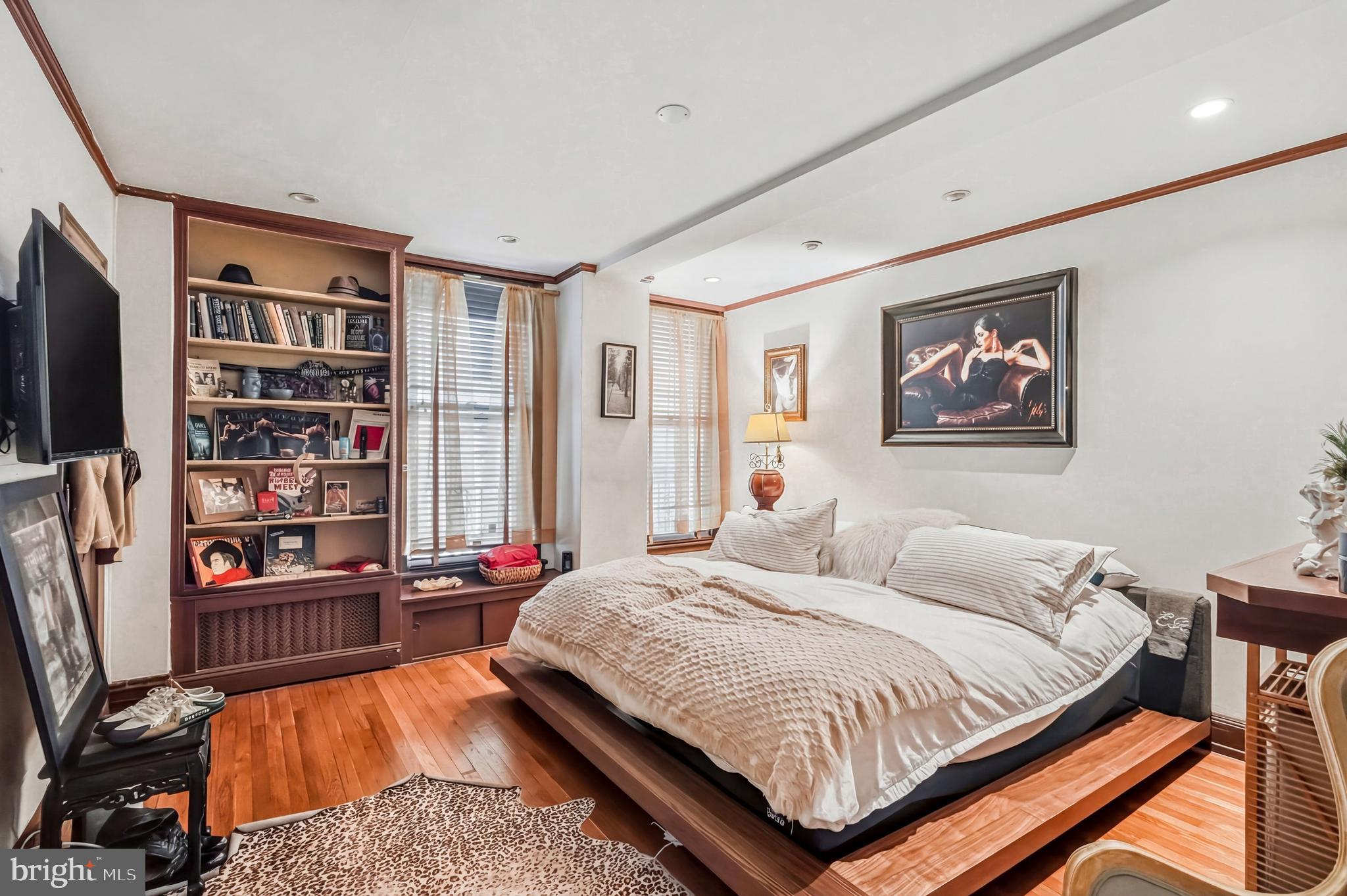 1901 Walnut Street, Unit 6F Philadelphia, PA 19103 - Photo 21 of 32 a bedroom with bed and a book shelf