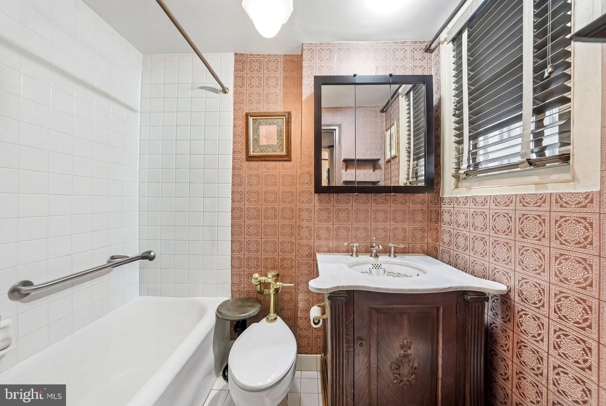 1901 Walnut Street, Unit 6F Philadelphia, PA 19103 - Photo 22 of 32 a bathroom with a toilet a sink and mirror