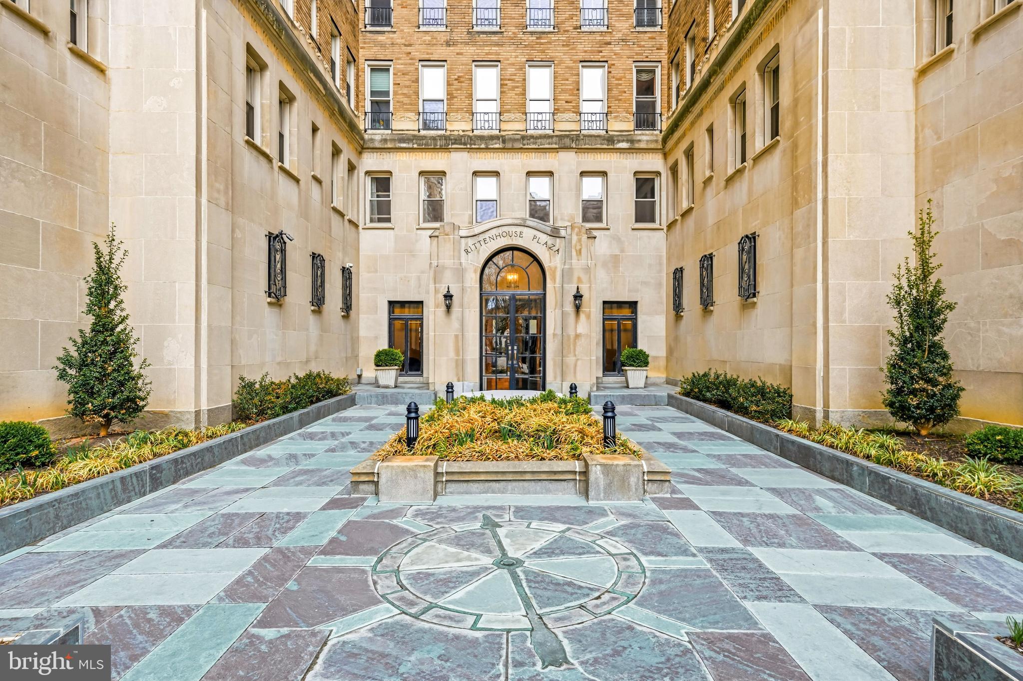 1901 Walnut Street, Unit 6F Philadelphia, PA 19103 - Photo 4 of 32 a front view of a multi story residential apartment building with yard and bench