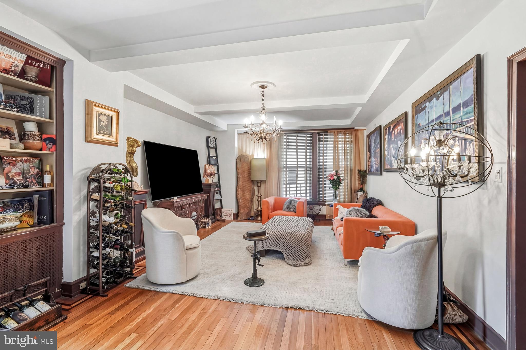1901 Walnut Street, Unit 6F Philadelphia, PA 19103 - Photo 6 of 32 a living room with furniture a flat screen tv and a floor to ceiling window