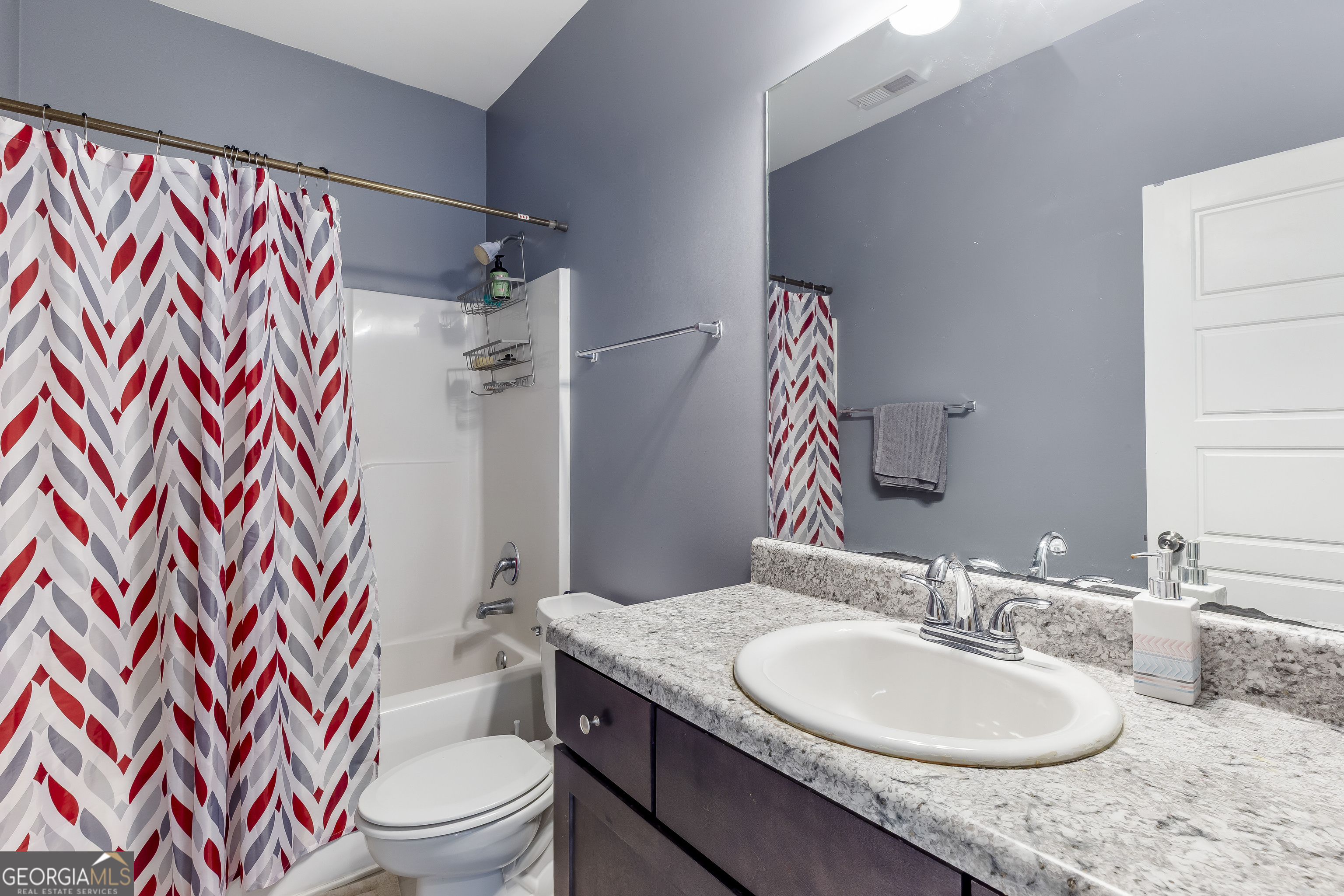 370 Springwater Way Bremen, GA 30110 - Photo 21 of 32 a bathroom with a granite countertop sink a toilet and shower curtain