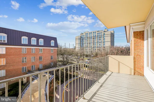 a view of a balcony with wooden floor and iron