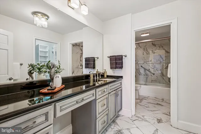 a kitchen with stainless steel appliances a sink stove and cabinets