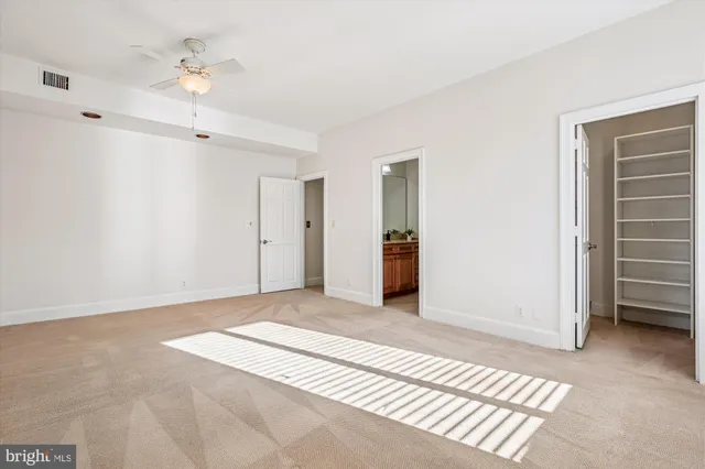 a view of an empty room with a ceiling fan