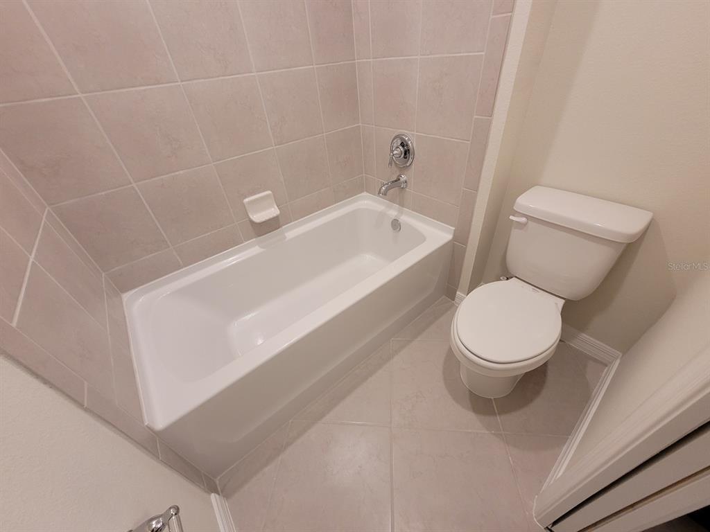 1264 Blue Is Drive Clermont, FL 34714 - Photo 56 of 56 a white toilet sitting next to a bath tub