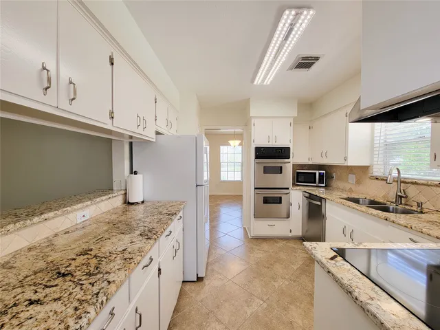 a kitchen with a sink stove and microwave