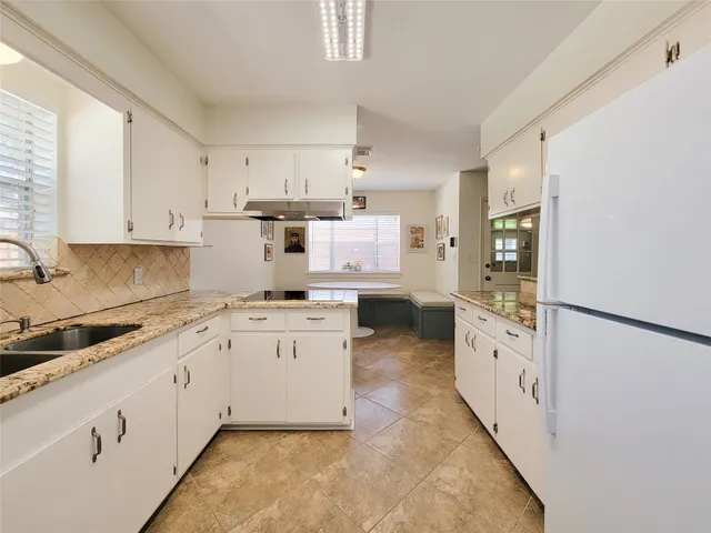 a kitchen with a sink and cabinets