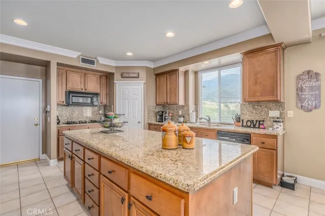 a kitchen with stainless steel appliances granite countertop a sink stove and cabinets