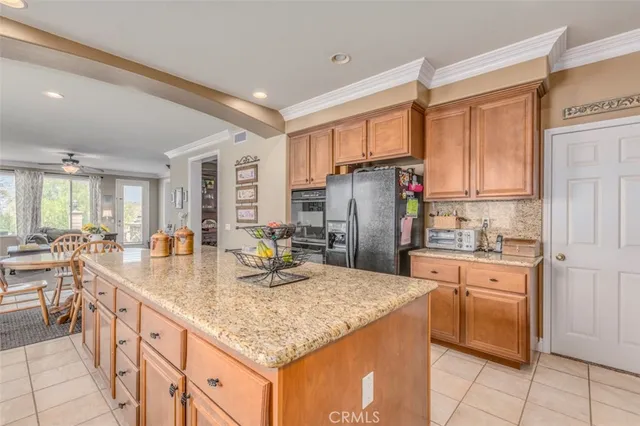 a kitchen with refrigerator and cabinets