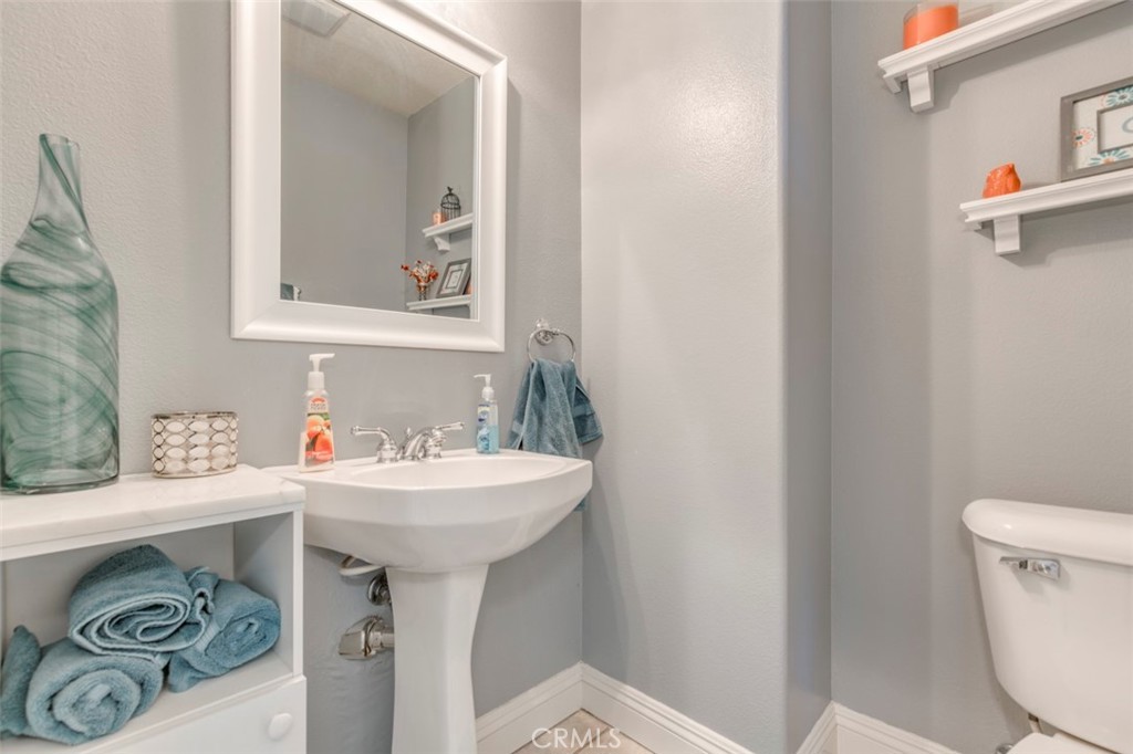980 Nicholas Place Corona, CA 92882 - Photo 20 of 46 a bathroom with a sink a toilet and mirror