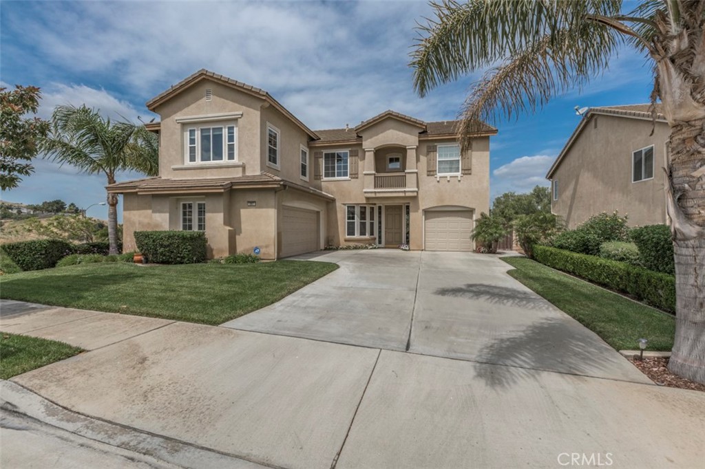 980 Nicholas Place Corona, CA 92882 - Photo 2 of 46 a front view of a house with a garden