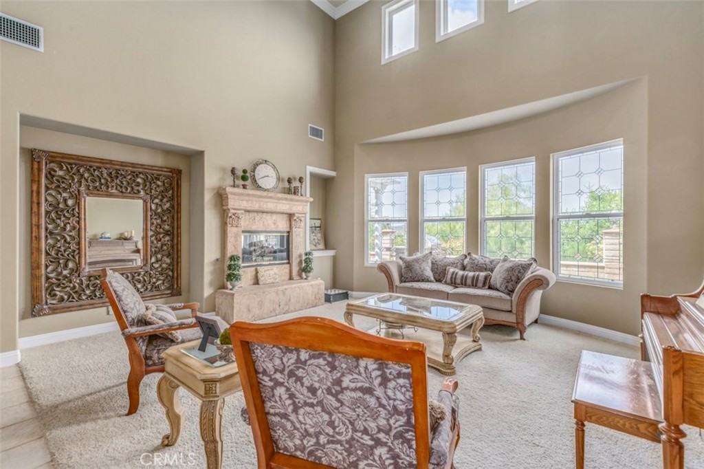 980 Nicholas Place Corona, CA 92882 - Photo 25 of 46 a living room with furniture a large window and a dining table