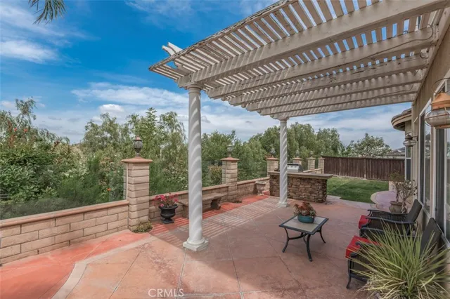 a view of a patio with a table chairs and a backyard