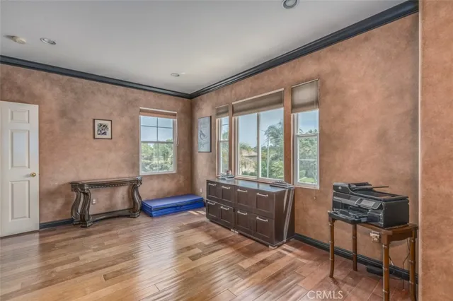 a spacious bedroom with a bed and a chandelier
