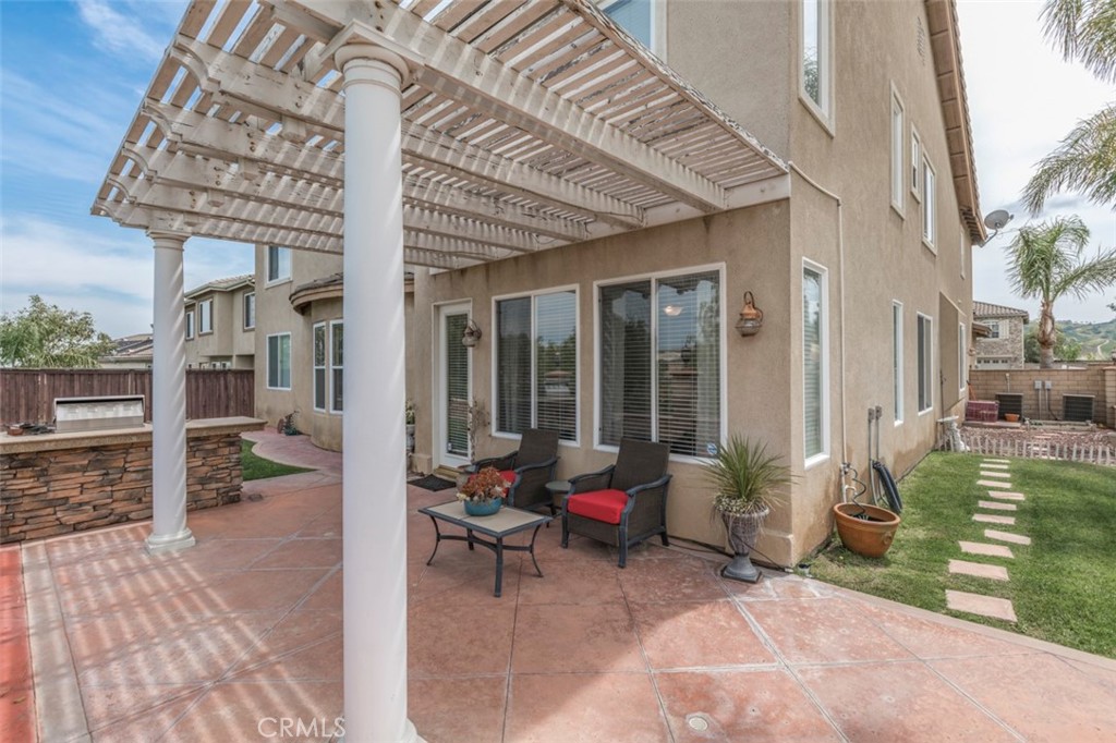 980 Nicholas Place Corona, CA 92882 - Photo 43 of 46 a view of a patio with table and chairs and potted plants