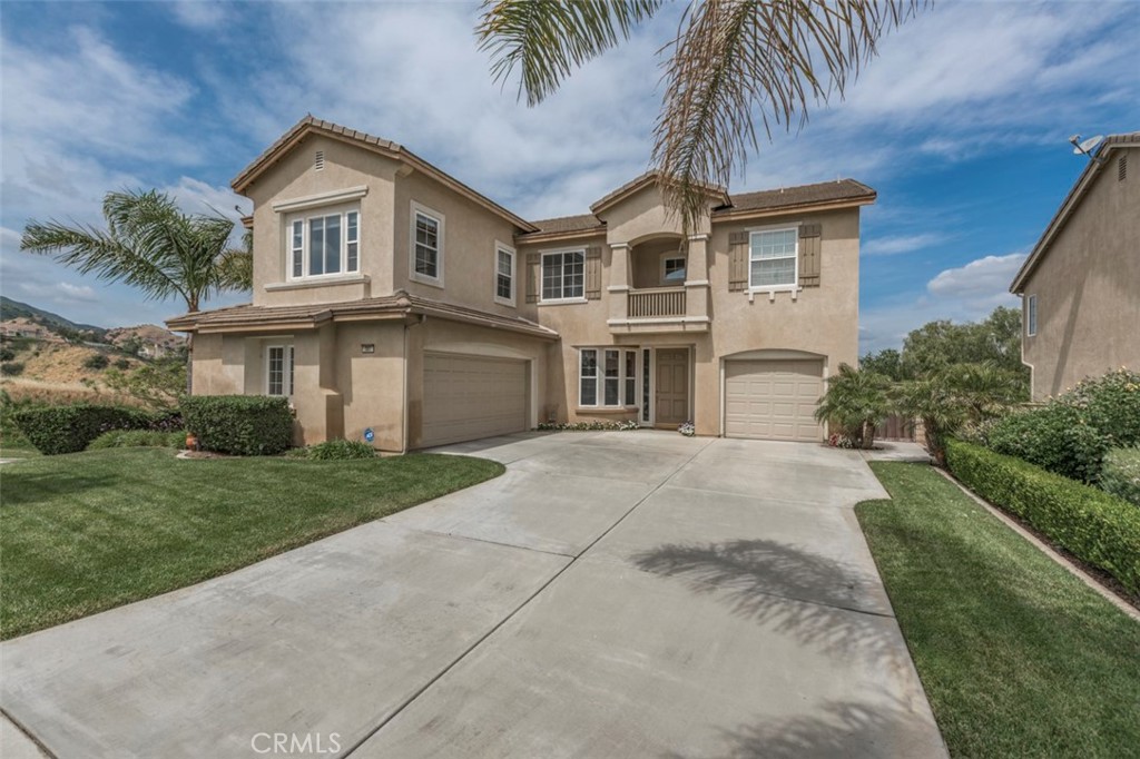 980 Nicholas Place Corona, CA 92882 - Photo 44 of 46 a front view of a house with a yard and garage