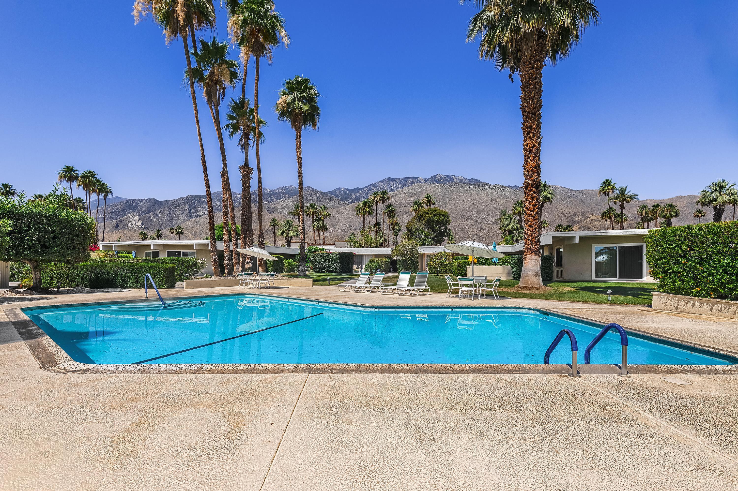 1855 Ramon Road, Unit 14 Palm Springs, CA 92264 - Photo 27 of 34 a view of a swimming pool and a terrace
