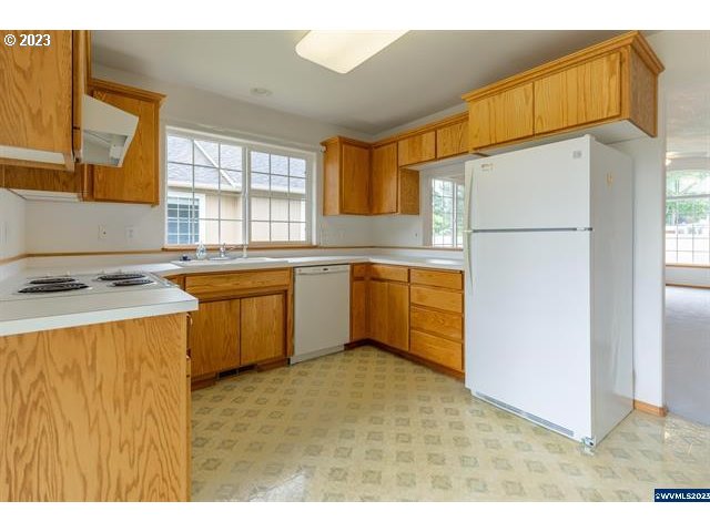 3014 View Lane Lebanon, OR 97355 - Photo 13 of 29 a kitchen with stainless steel appliances granite countertop a refrigerator a sink dishwasher with a dining table and chair