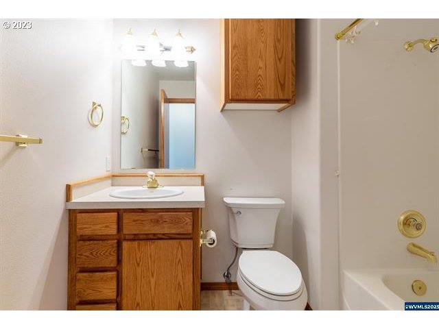 3014 View Lane Lebanon, OR 97355 - Photo 16 of 29 a bathroom with a sink a toilet and mirror