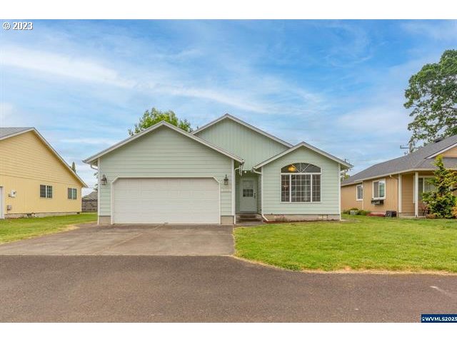 3014 View Lane Lebanon, OR 97355 - Photo 22 of 29 a front view of a house with a yard and garage