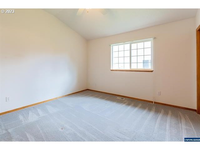 3014 View Lane Lebanon, OR 97355 - Photo 9 of 29 an empty room with wooden floor and windows