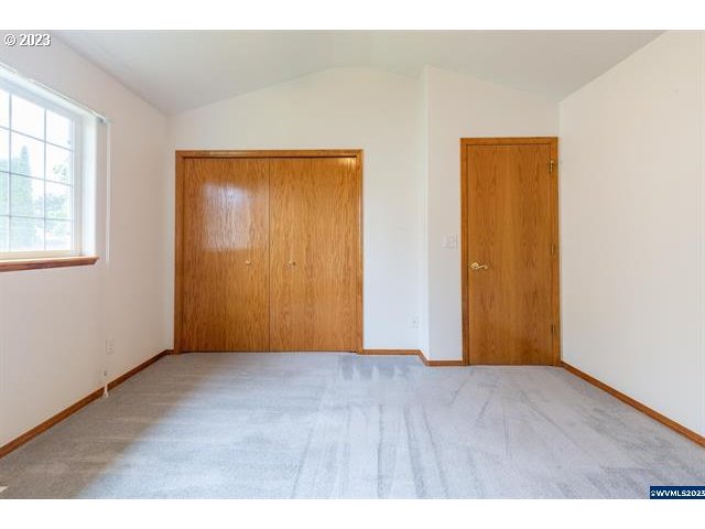 3014 View Lane Lebanon, OR 97355 - Photo 10 of 29 an empty room with wooden floor and windows