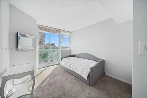 a bed sitting in a room next to a window