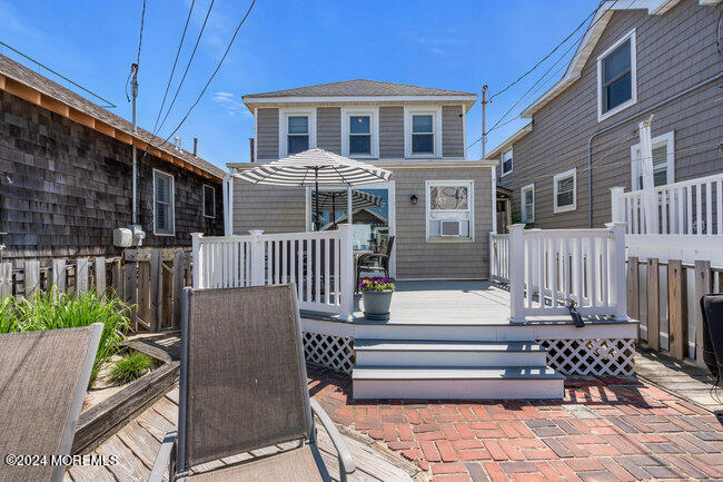 157 Beach Front Manasquan, NJ 08736 - Photo 11 of 47 a front view of a house with a bench