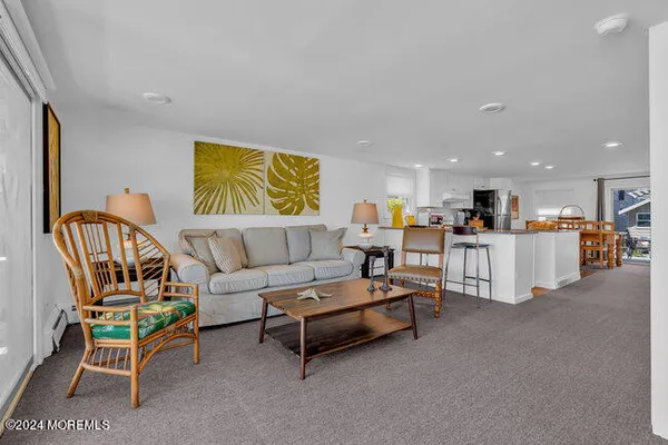 a living room with furniture and kitchen view