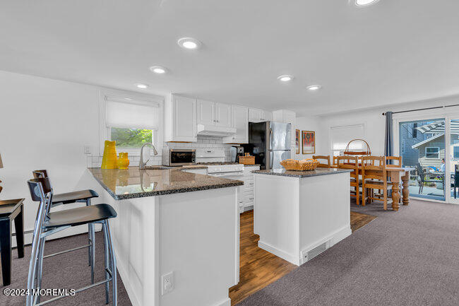 157 Beach Front Manasquan, NJ 08736 - Photo 18 of 47 a kitchen with stainless steel appliances kitchen island granite countertop a sink and cabinets
