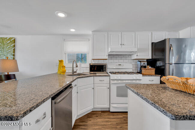 157 Beach Front Manasquan, NJ 08736 - Photo 19 of 47 a kitchen with granite countertop a sink a counter top space appliances and cabinets