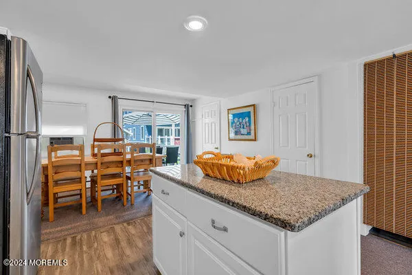 a kitchen with stainless steel appliances granite countertop a sink and a refrigerator