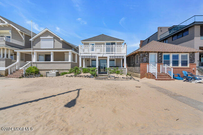 157 Beach Front Manasquan, NJ 08736 - Photo 2 of 47 a front view of a house with a yard and a garage