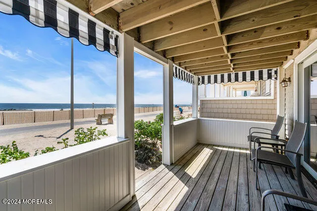 a view of balcony with wooden floor and outdoor seating