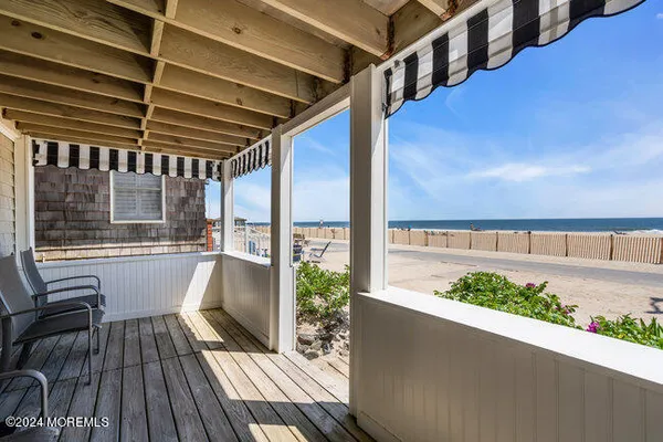 a view of balcony with wooden floor and outdoor seating
