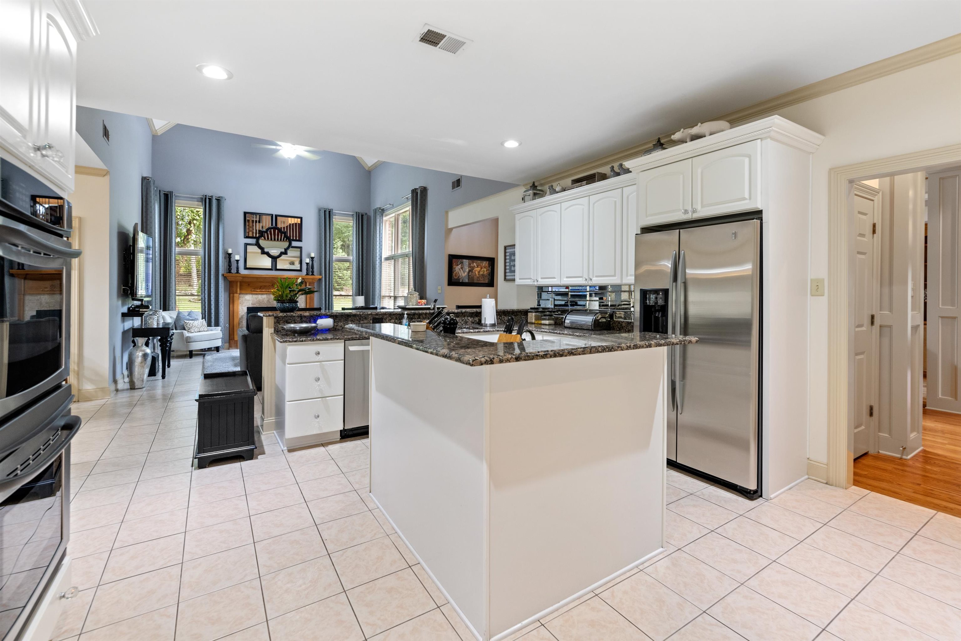 11241 Latting Road Eads, TN 38028 - Photo 9 of 31 a kitchen with stainless steel appliances kitchen island granite countertop a refrigerator a stove and a sink